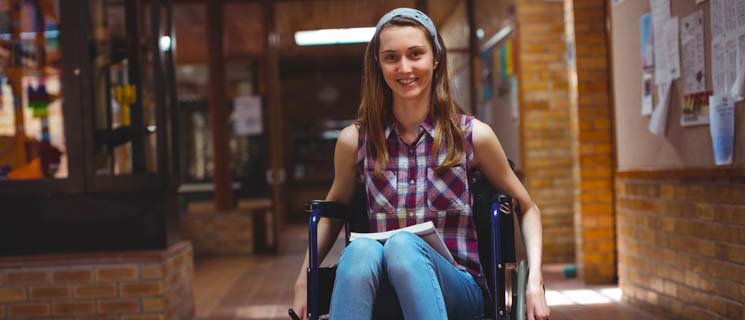 Student in wheelchair in school hallway