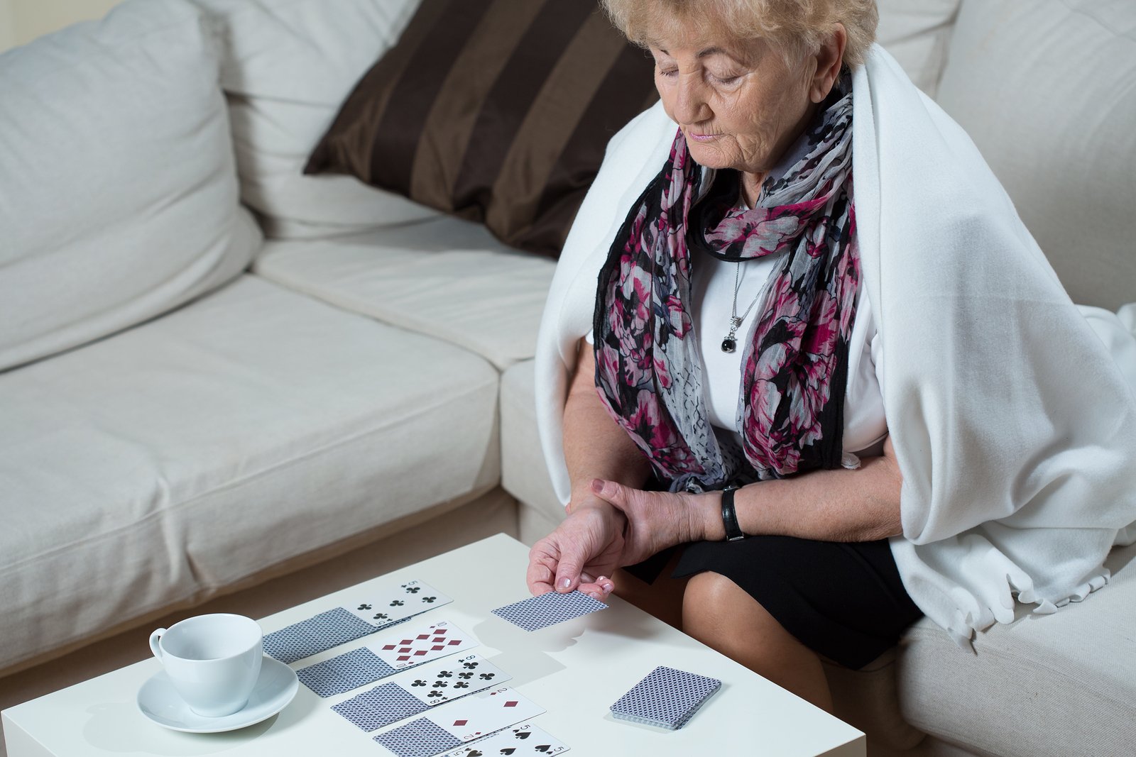 Senior Woman Playing Cards Alone