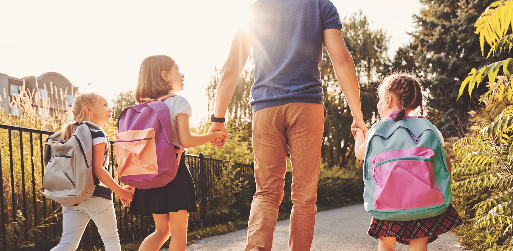 Father walking daughters to school